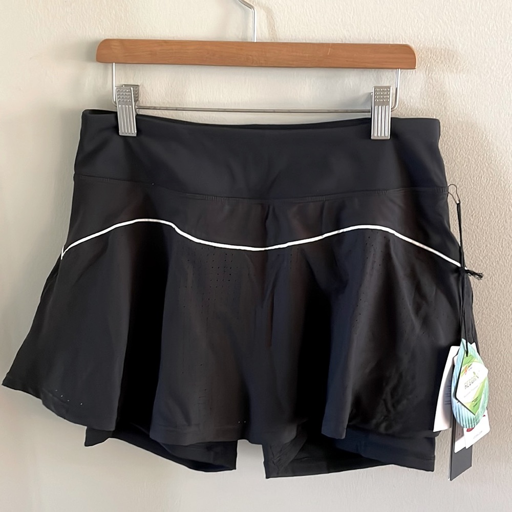 Brand-new tennis skirt with ball pocket on left leg and zipper pocket on back